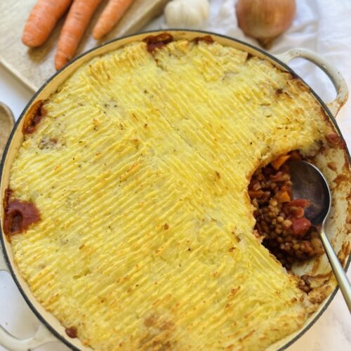 cooked cottage or shepherd's pie in a cast iron serving dish