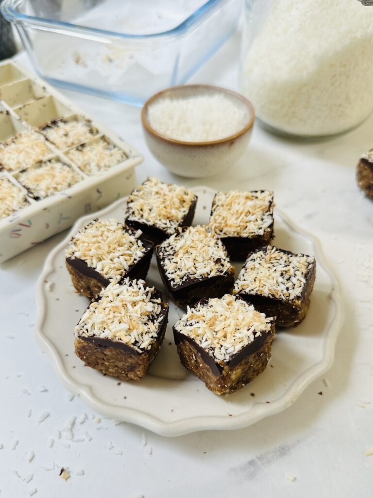 mini apricot bites made in an ice cube tray with dates and coconut