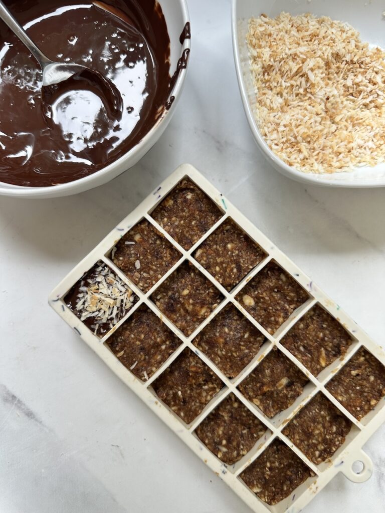 mini apricot bites made in an ice cube tray with dates and coconut without chocolate topping