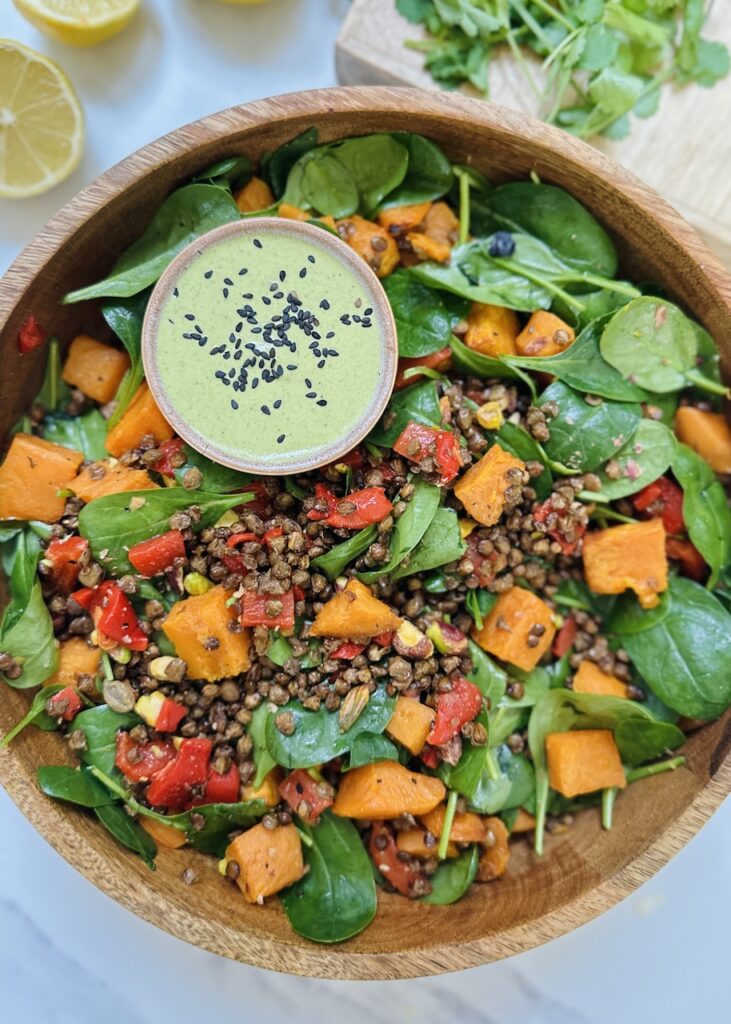crispy lentil salad with sweet potatoes, peppers and pistachio green dressing