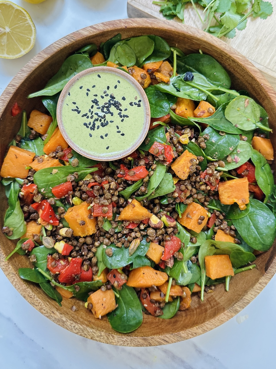 crispy lentil salad with sweet potatoes, peppers and pistachio green dressing