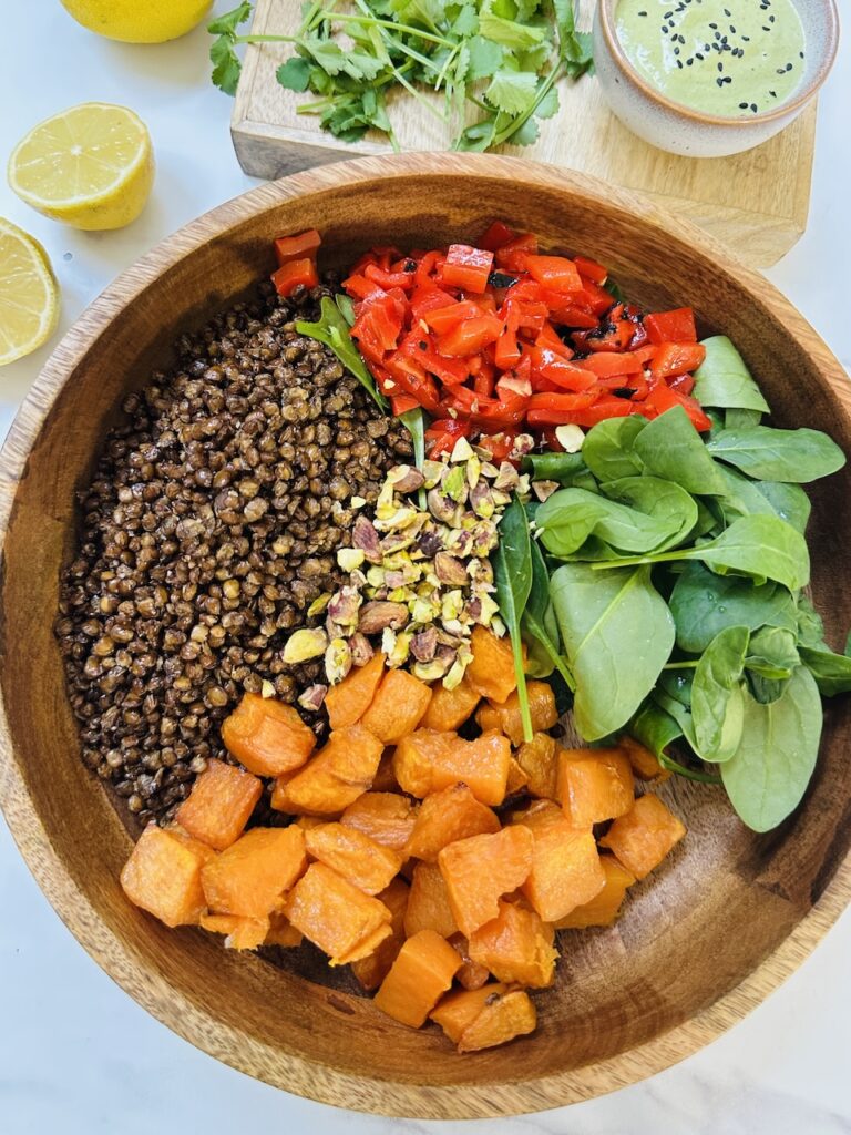 crispy lentil salad with sweet potatoes, peppers and pistachio green dressing