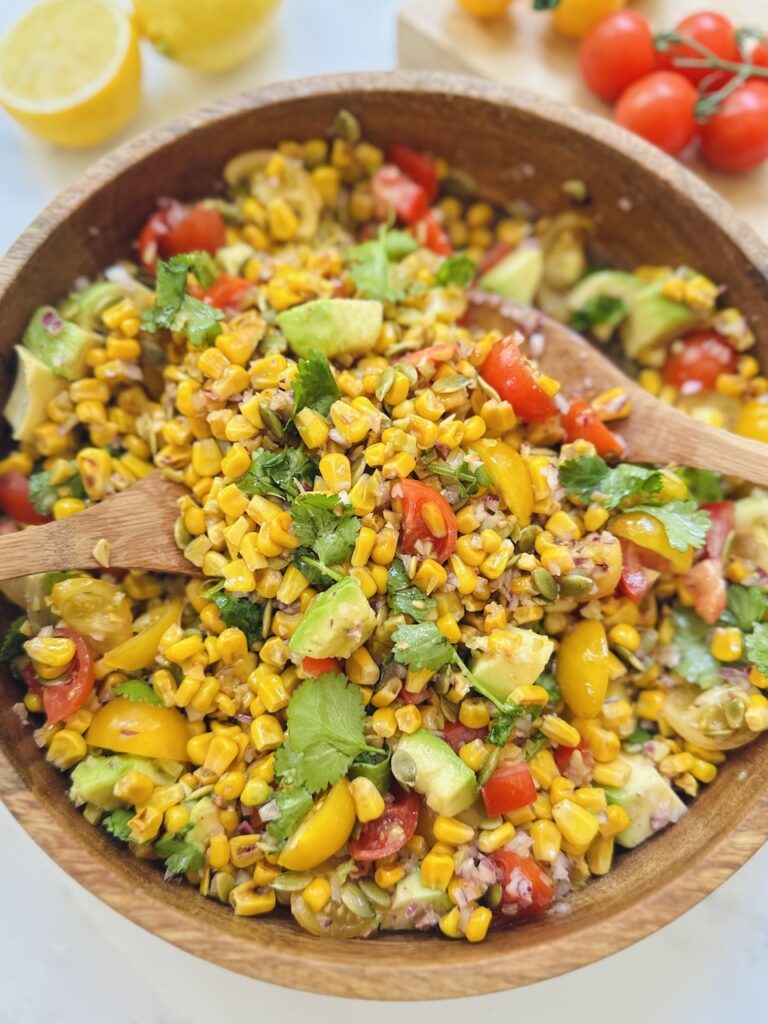 charred corn salad with tomatoes, olives, avocado and cilantro