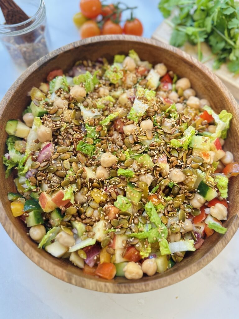chopped veggies salad with chickpeas and toasted seeds