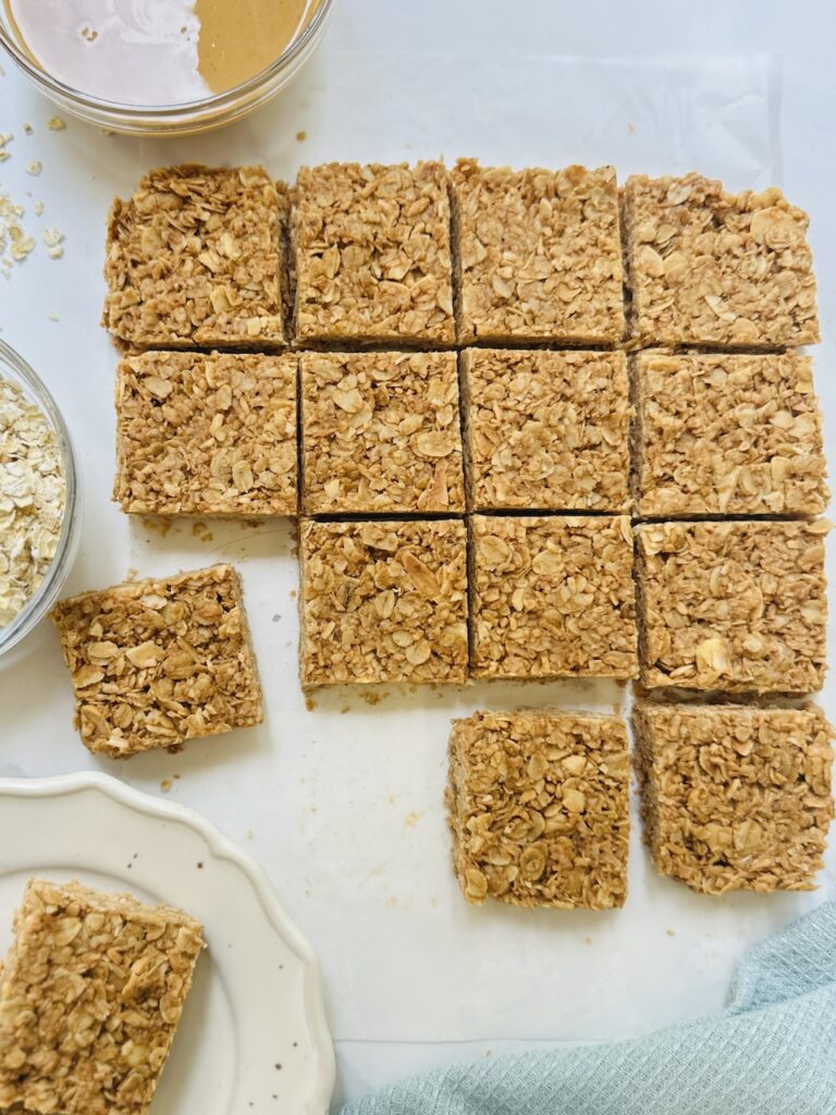 no bake oat bars with coconut and almonds cut on a board