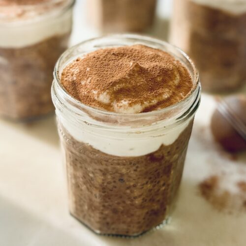 mocha overnight oats in 4 jars with yoghurt n top and cacao dusting