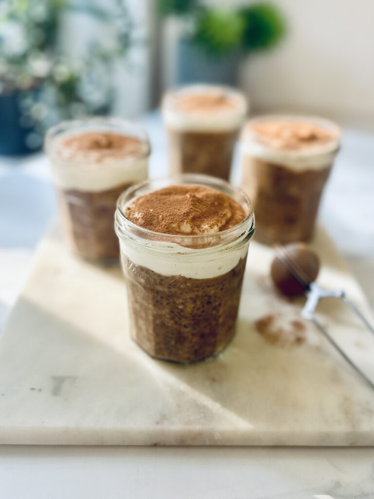 mocha overnight oats in 4 jars with yoghurt n top and cacao dusting