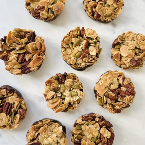 nut clusters on a marble background made with pecans, almonds and pumpkin seeds