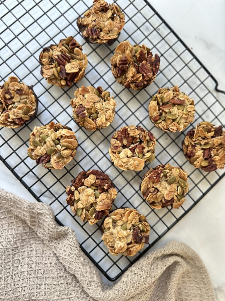 nut clusters on a black cooling rack made with pecans, almonds and pumpkin seeds