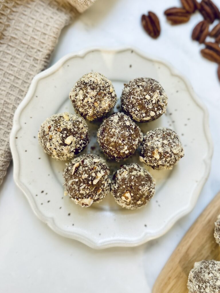 pecan pie energy ball on a circular white plate